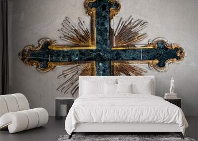 An intricate cross with gold inlay and marble is fixed to a wall in a Catholic Cathedral in Rome, Italy. Wall mural