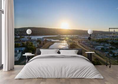 Aerial photo looking out over Launceston above the North Esk River at sunset with blue sky Wall mural