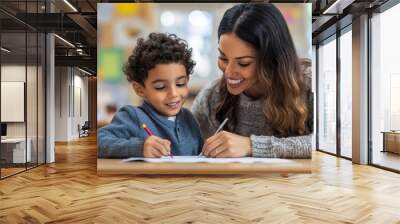 Female infant school teacher working one on one with a young schoolboy, sitting at a table writing in a classroom, front view, Generative AI Wall mural