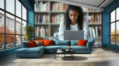 Focused black teenager sitting on floor with learning materials and laptop at home, studying remotely, attending online lecture or seminar, chatting with college, Generative AI Wall mural