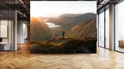 Hiker at top of mountain, Sunset Panorama Wall mural