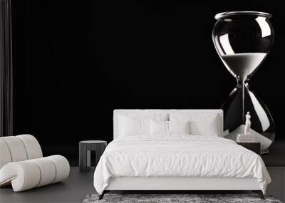 Hourglass on a black background, shown in closeup view with copy space. Wall mural