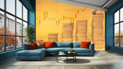 Increasing piles of coins with candle stick graph chart and financial data in stock market in background. Concept for financial growth Wall mural