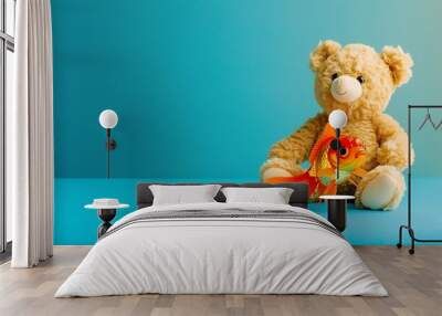 Teddy bear with a goldfish isolated on colorful background Wall mural