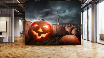 A carved glowing halloween pumpkin in a field at night. Photo composite. Wall mural