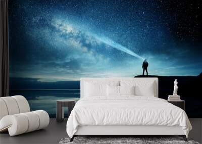 A person standing and watching the Milky Way galaxy rise into the night sky. Photo Composite Wall mural