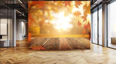 A rustic old wooden table outdoors with autumn leaves falling in the background. Wall mural