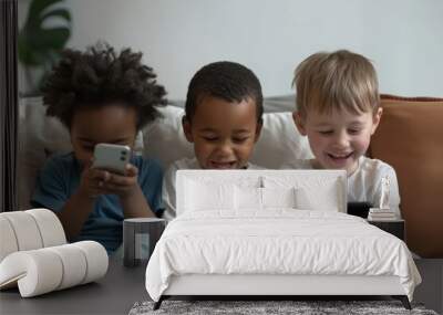 Three multiethnic little boys spend time on internet sit together on sofa look at phone screen, laugh, watching funny video, use new application. tech and younger generation, bad habit, Generative AI Wall mural