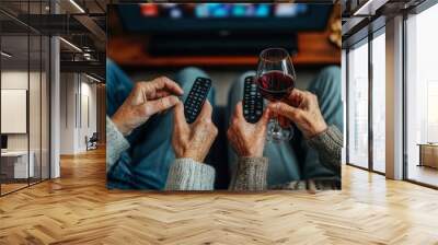 Top view closeup of unrecognizable senior couple watching TV together with hands holding remote control and wine glasses copy space, Generative AI Wall mural