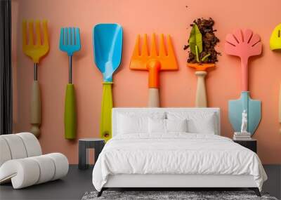 Toy gardening tools isolated on amber and peach background Wall mural