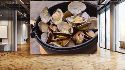 Garlic white wine clam in black pot on wooden tray in asian rest Wall mural