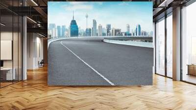 Curvy flyover highway asphalt road with cityscape skyline , noon scene . Wall mural