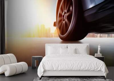 Low angle side view of car driving fast at sunset with motion speed effect . Wall mural