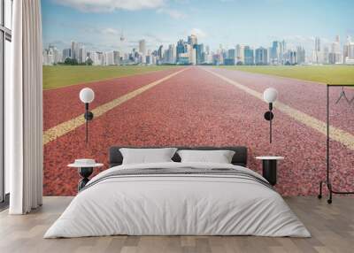 Red running track with city background . Wall mural