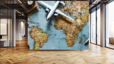 A beautiful world map with a toy airplane on top of it Wall mural