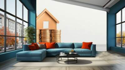 A wooden house model placed on stacked coins, symbolizing real estate investment and financial growth in property market. Wall mural