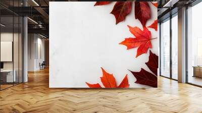 Autumn leaves in vibrant colors on a marble countertop, white isolated background. Wall mural