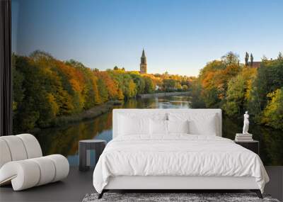 Beautiful fall foliage and Aura river against clear blue sky with Turku Cathedral in background in Turku, Finland, Autumn 2018 Wall mural