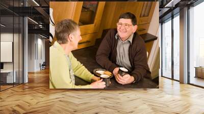 senior couple talking in kitchen Wall mural