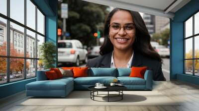 confident maori businesswoman smiling on a city street with traffic in the background Wall mural