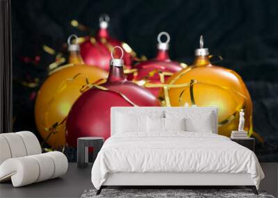 Red and yellow Christmas balls on a black backdrop Wall mural