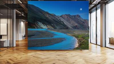 Night view to colorful mountain ridge and river flowing down in valley with sheep eating grass, Landmannalaugar, Iceland Wall mural