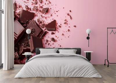 Scattered dark chocolate bars and shavings on a delicate pink background. Wall mural