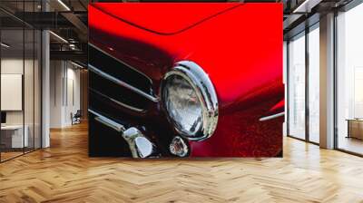 Vintage old red car headlight detail. Retro car lamp. Wall mural