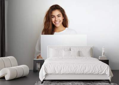 Young woman holding a blank sign Wall mural