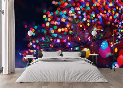  A vibrant display of multicolored lights on an outdoor Christmas tree, creating a bokeh effect against a dark background. Copy space. Phone screen wallpaper. Wall mural