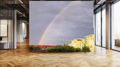 rainbow at the cloudy sky after the storm over the city Wall mural