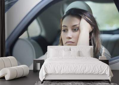 Bored woman waiting patiently in her car Wall mural