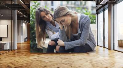 Woman comforting to a sad depressed friend who needs help. Depression concept Wall mural