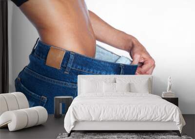 young woman in blue jeans showing her belly. Weight loss concept Wall mural