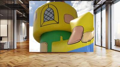 Bouncy castle tower with cloudy sky Wall mural