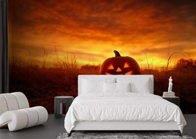 Cheerful jack-o'-lantern with a grin on earth, amidst golden leaves under a starry sky and a distant moon, capturing the essence of Halloween Wall mural