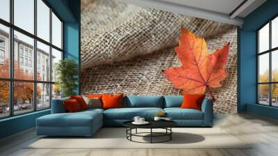 Closeup of a single autumn leaf on a rustic fabric Wall mural