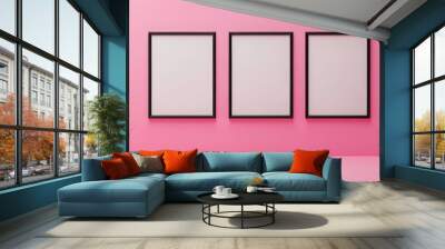 Three black picture frames on pink background Wall mural