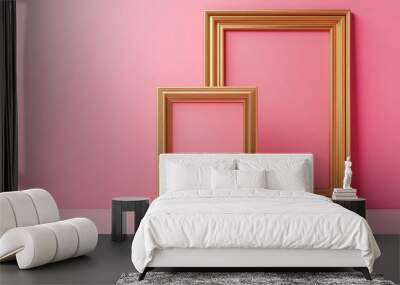 Two gold picture frames on pink background Wall mural