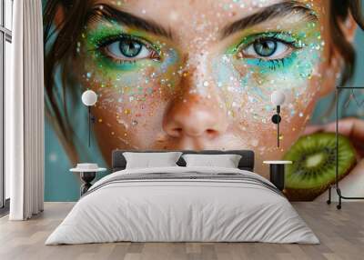 Young woman with bright make up and kiwi close up portrait, beautiful caucasian woman with drops and sparkles on her face Wall mural