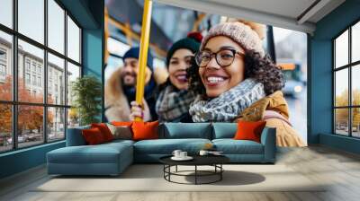 A cheerful young woman smiles while boarding a bus with friends, representing a positive travel experience, public transportation, and group adventures. Wall mural