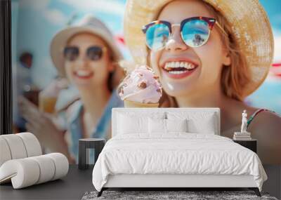 Lifestyle portrait of a group of friends eating ice cream, having fun together at the seaside or city park on a summer day. Wall mural