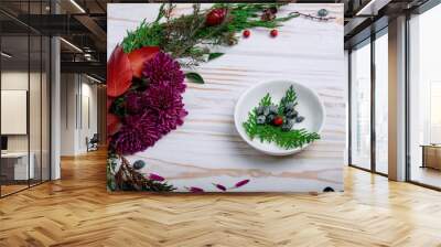 Twig sprig in a white plate on the table with New Year's decor Wall mural