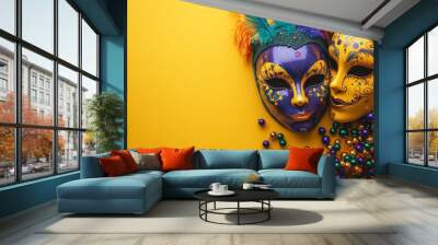 Two glittering Mardi Gras masks, one purple and one yellow, with feathers and beads, placed on a yellow background, symbolizing festivity and carnival spirit. Wall mural