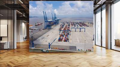 Aerial view, top view cargo ship port in the export, import by ship business and logistics international goods. Logistics and transportation of container cargo ship working crane bridge in shipyard Wall mural