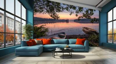 Scenic sunset view with two row boat and idyllic lake at summer night in Finland Wall mural