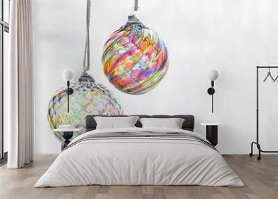 Photograph of two glass blown Christmas tree ornaments suspended against a white background Wall mural