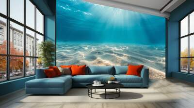 Underwater view of rippling sandy ocean floor bathed in beautiful sunlight beams, creating a serene and tranquil marine seascape. Wall mural