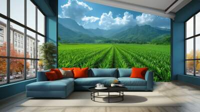 An expansive green field with precisely aligned rows of crops unfolds under a pristine blue sky, embodying the harmony of agriculture and natural beauty in a breathtaking landscape. Wall mural