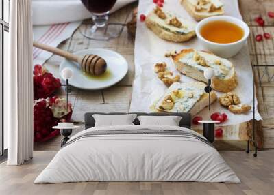 Sandwiches with blue cheese, pomegranate, honey and nuts served with red wine. Rustic style. Wall mural